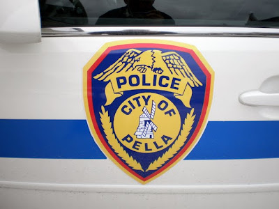 Badge on the side of a Pella Police cruiser