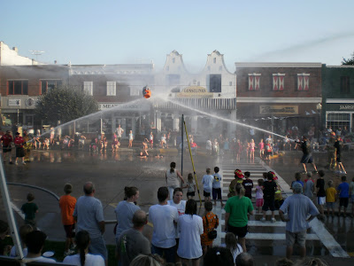 Kids enjoy the cool spray during this water fight match at Thursdays in Pella