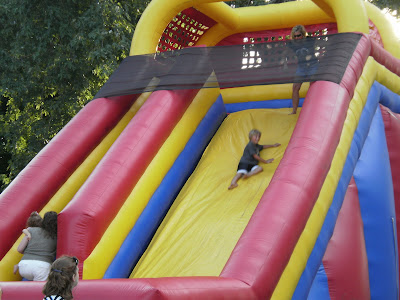 A boy takes a turn down an inflatable slide at one of the summer's Thursdays in Pella events