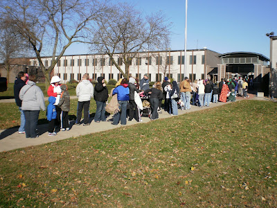 People wait in line outside of the Pella High School to receive H1N1 vaccinations