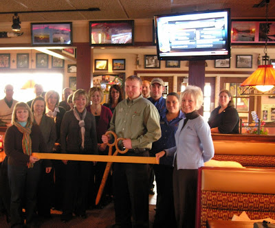 Applebee's General Manager Justin Trenkamp is surrounded by the Dutch Greeters at a ribbon-cutting November 16th