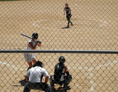 Pella's Mandy DeMeulenaere send the pitch toward Knoxville's Katie Ayers