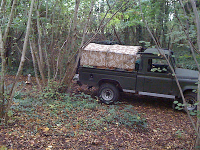 The Landrover is almost completely camouflaged with the mix of green and autumn leaf colours...