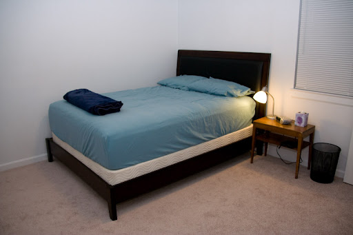 New bed with new sheets and some other furniture