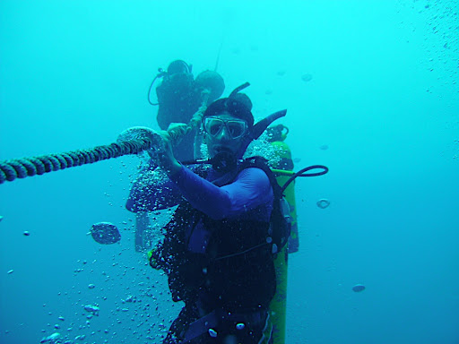 Laszlo hanging onto the line as we make our slow ascent to the surface.