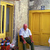 (2001) Old Jasenčić sitting in his typical pose, seling home made wine, home brew and tomatoes ...