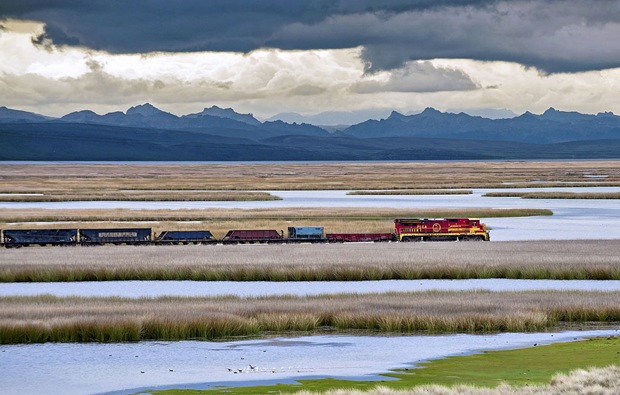 Train passes beside a beautiful landscape beside the Andes Mountain during the Southern Hemisphere summer. Train passes beside a beautiful landscape beside the Andes Mountain during the Southern Hemisphere summer.