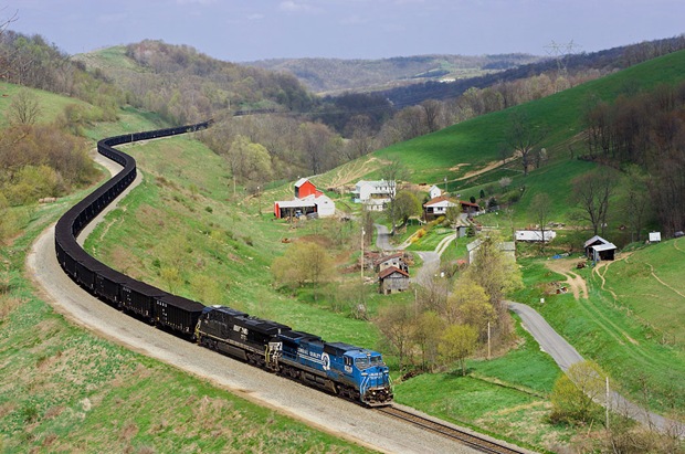 A weathered ExConrail Dash-8 train fills the quiet green valley the Manor Branch at Time in Pennsylvania A weathered ExConrail Dash-8 train fills the quiet green valley the Manor Branch at Time in Pennsylvania