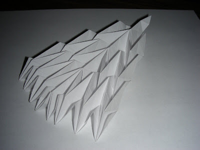 Collapsed diagonal v-shaped origami accordion bottom view