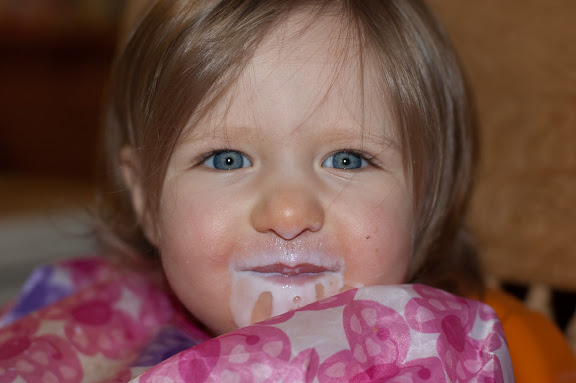 Big girl drinking her milk from a CUP.
