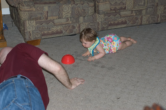 And Sam finally has figured out that she can drag herself forward a few inches to get something.  She's REALLY close to crawling.
