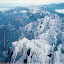 Spine of upthrust limestone mountain range above town (orange line is scratch on original photo) Spine of upthrust limestone mountain range above town (orange line is scratch on original photo)