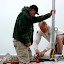 Stephen assists Kevin with mast raising