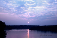 This is the sun setting over the Falls Lake Dam in Wakefield, North Carolina. This is the sun setting over the Falls Lake Dam in Wakefield, North Carolina.