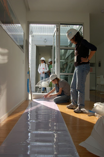 Installing our walkway covering;  100,000+ guests walking through your house can do some pretty damaging things to your bamboo flooring, or so we hear.