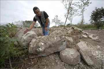 An archaeologist for the National Anthropology and History Institute, or INAH, Angel Gongora, shows some remains of an ancient Mayan residential complex some 2,300 years old that was destroyed. EFE An archaeologist for the National Anthropology and History Institute, or INAH, Angel Gongora, shows some remains of an ancient Mayan residential complex some 2,300 years old that was destroyed. EFE