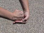 Grasp the fist with your other hand similar to the Heimlich technique. Grasp the fist with your other hand similar to the Heimlich technique.