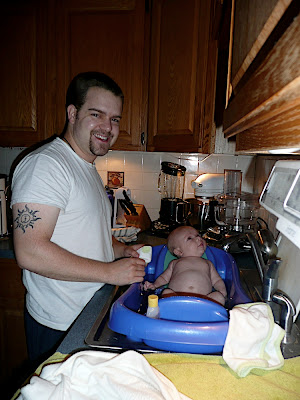 Daddy giving me a bath. I like looking at the tiles on the wall.