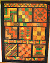 “Three Easy Pieces”. This is the quintessential beginner Sampler Quilt. It features 9, 15 - 16 inch blocks and complementary border strips all made using the three basics units of patchwork - squares, rectangles and triangles. Skill level: beginner.