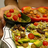 Zucchini slices topped with seed/veggie pate and covered in avocado chunks, sugar plum tomatoes, radish sprouts, marinated/dehydrated eggplant, and some pepper/nutritional yeast. In the back is a red bell pepper boat with nut/seed pate topped with marinated/dehydrated squash and onion with some tomatoes on top. Plus an avocado with the nut/seed pate and tomatoes. Booya!