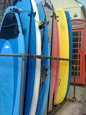 Surfboards leaning against a wall in Newquay, England