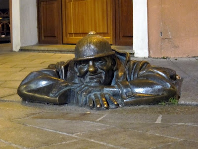 Sculpture of a man coming out of a manhole in Bratislava Slovakia