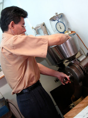 The proprietor grinding coffee for me.