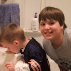 Aaron helping Logan brush his teeth