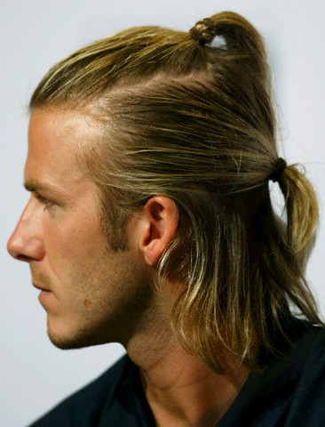 07 Aug 2003, Hong Kong, China --- Real Madrid's David Beckham wearing his hair in two ponytails, looks on during a news conference in Hong Kong August 7, 2003. --- Image by © Bobby Yip/Reuters/Corbis
