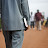 Pastor walking on busy street carrying bible Pastor walking on busy street carrying bible