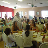 Fr. Basil Rhodes hands out the daily Bible Questions to campers at Breakfast
