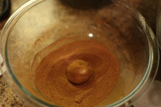 picture of dough balls being coated in the cinnamon-sugar mixture