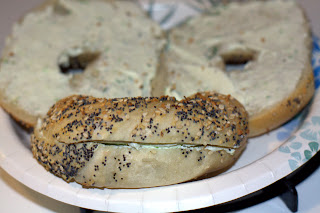 picture of one closed bagel and one open bagel arranged to resemble a face, the open halves are the eyes and the closed bagel is the mouth