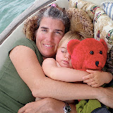 Hil and Emma napping with red bear in the cockpit.