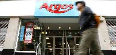 A walking passes a bend of Argos in senior manager London