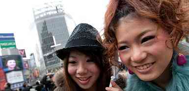 Young women attend to mobile ringtones