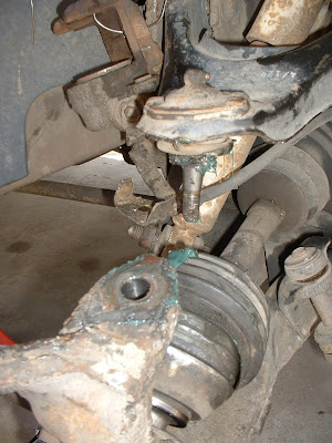 Once that is loose the spindle and hub drops down and theres FINALLY enough room to pull the old drive axle out!  Very gratifying moment.