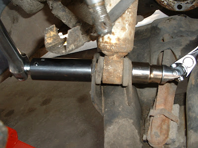 The axle doesnt NEED to be out to change shocks, but there sure is a lot more room, so its best to do that before the new axle goes in.  First I just cracked loose the bolts holding the shock in the mount.