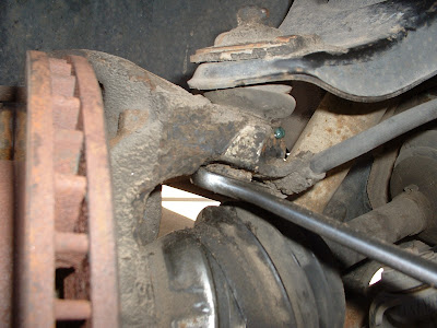 Once the tie rods are out you can pull the pin and take off the nut for the upper ball joint.
