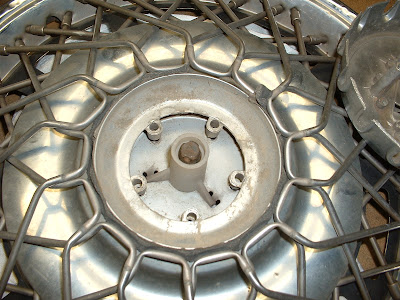 Once the center piece is off, you can get to all the spokes.  They simply pull out, although some are more stubborn than others!