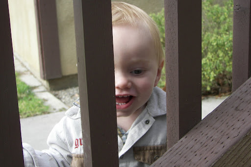 Hyrum thinks looking through the bars is tres cool.