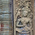 Like her sister on the south door frame, Sikhoraphum's north devata also has much in common with the women at Angkor Wat. Her jewelry, hand gestures, plants, stomach markings, sampot (Khmer skirt) are all similar. Again, the animals make this carving quite rare - out of 1,780 women at Angkor Wat only a few hold a single bird, and only one (!) has a small dog as a pet. Read the full story on http://www.devata.org
