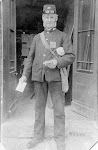 Mr Bellamy, the post man, outside the Old Forge
