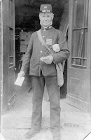 Mr Bellamy, the post man, outside the Old Forge