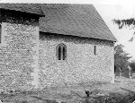 St Mary's Church. The church chancel exterior from the south showing the flint-faced wall and Norman windows. Copyright © Oxfordshire County Council Photographic Archive. Reproduced with the kind permission of Oxfordshire Studies. This photograph may be purchased from their Heritage Search web site at http://www.oxfordshire.gov.uk/heritagesearch