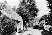 High Street, showing Sign of the Crown and the Old Forge on the right. Cottages on the left were demolished in the 1960s