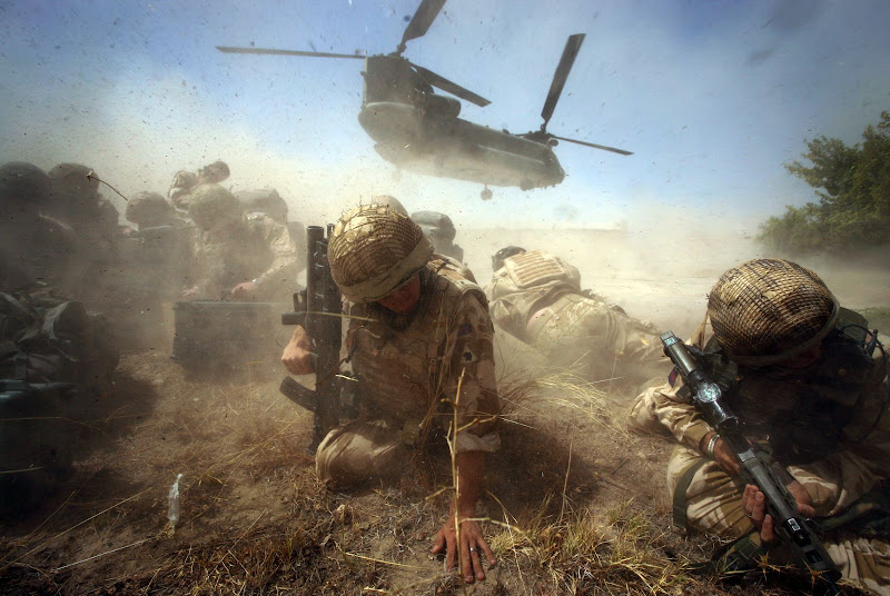 British army troops shelter from the dust storm as their chinook helicopter departs from Cher-E-Anjir town in Helmand Province, Afghanstan, August 12th 2009. A local building in the area has been taken over by the British armed forces Prince of Waless Company as an outpost of the Welsh Guards regiment in Nad-E-Ali. Credit: Susannah Ireland / The Independent British army troops shelter from the dust storm as their chinook helicopter departs from Cher-E-Anjir town in Helmand Province, Afghanstan, August 12th 2009. A local building in the area has been taken over by the British armed forces Prince of Waless Company as an outpost of the Welsh Guards regiment in Nad-E-Ali. Credit: Susannah Ireland / The Independent