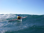 Inuit paddle exiting the water in high wind on Lake Michigan. Summer storm sea kayaking. http://keithwikle.com