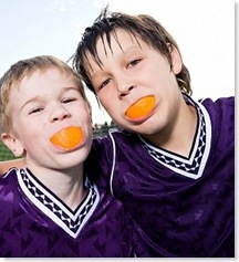 2boys-with-orange-wedges