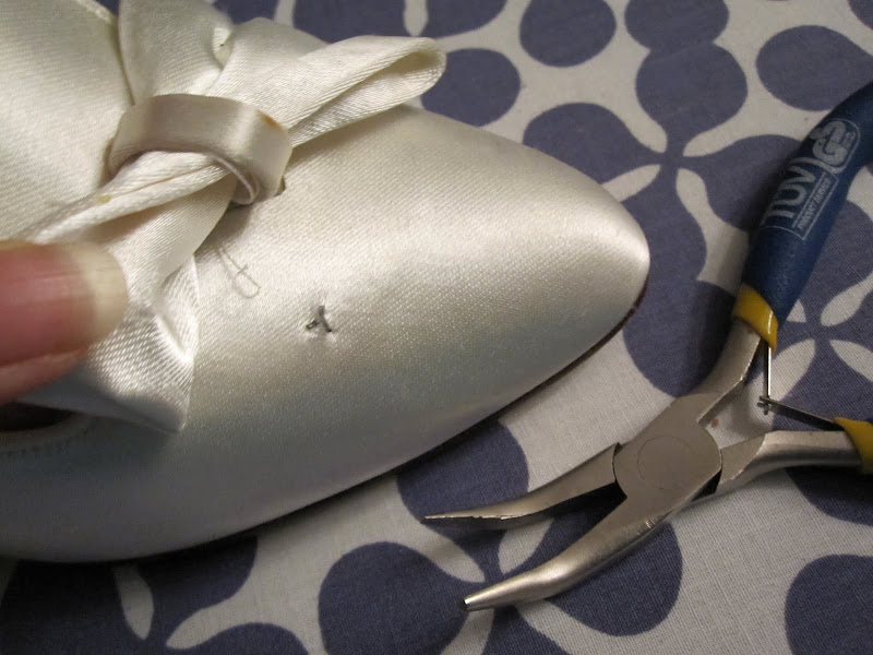 Using pliers to get the bows off the shoe Using pliers to get the bows off the shoe